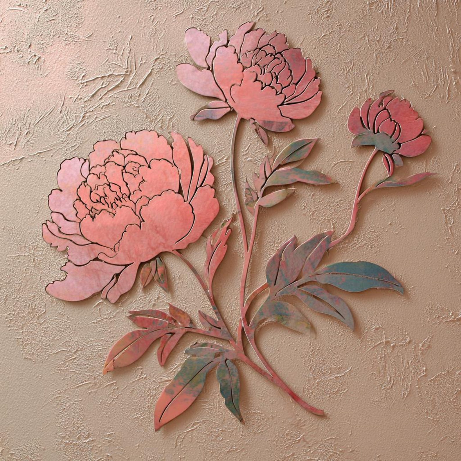 Blush pink peony metal wall art with elegant botanical floral design mounted on textured wall 1