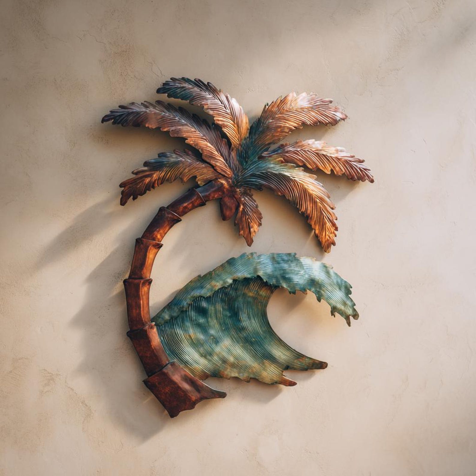 Palm tree ocean wave metal wall art with tropical coastal design mounted on beige wall 1
